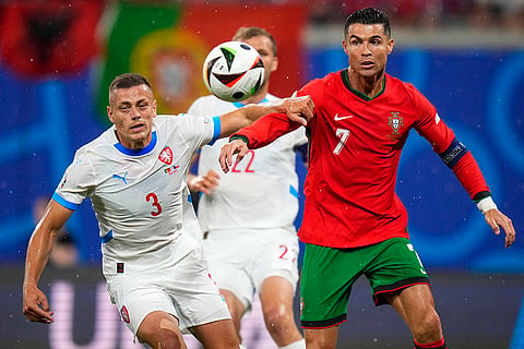 Cristiano Ronaldo duels for the ball with Tomas Holes